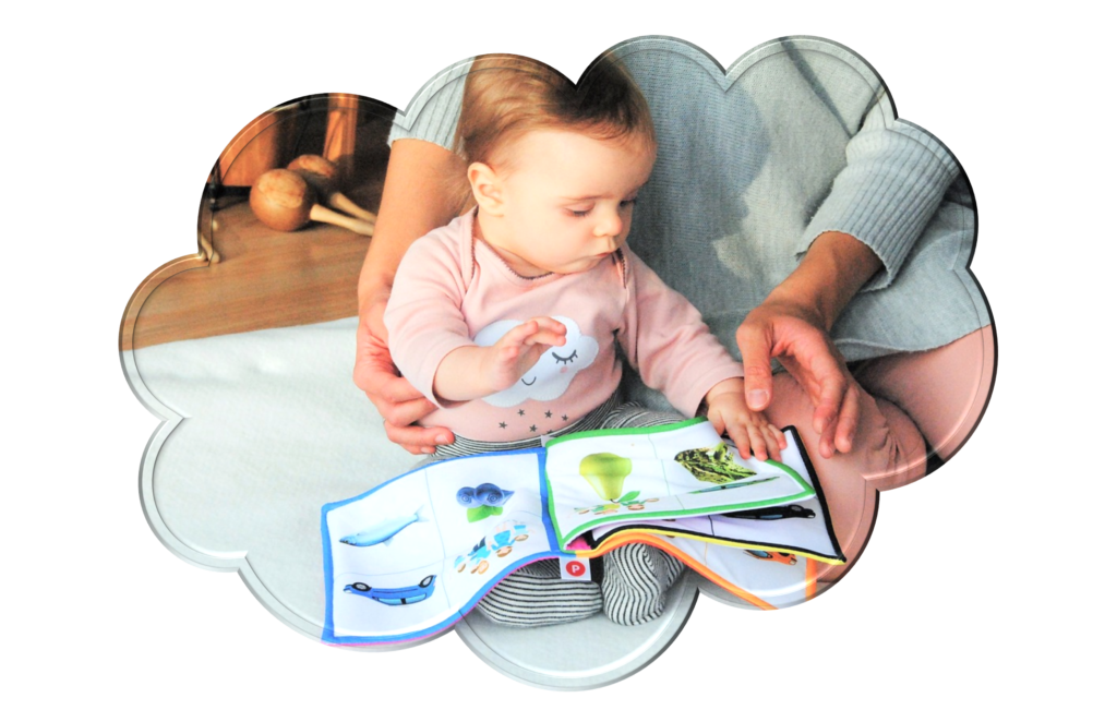 Cloud shape image of young child looking at a book with adult sat by them